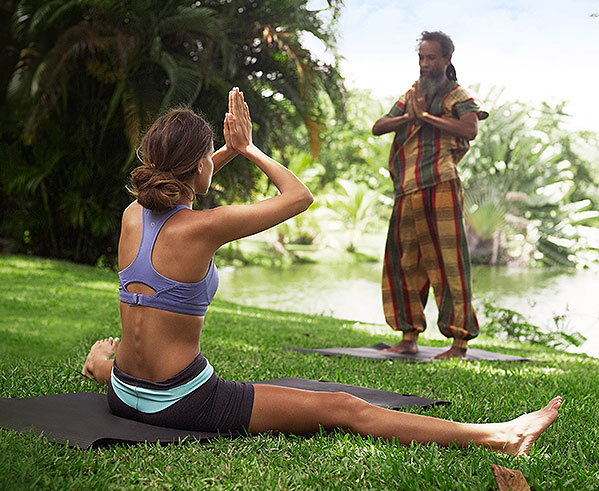 woman participating in yoga session on grass
