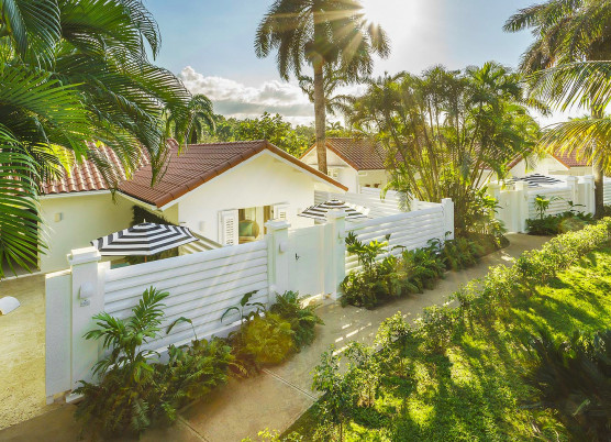small yellow private villa buildings with individual yards with white fences