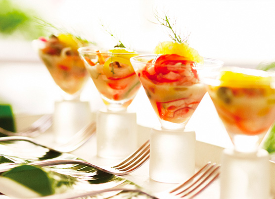 small martini cups with fish appetizer on a tray
