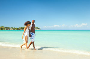 Couple walking along the sea shore 